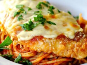 Chicken Parmigiana Breaded chicken topped with mozzarella cheese and tomato sauce, served with  your choice of penne, spaghetti, or house salad.