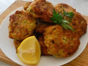 Kolokithokeftedes Zucchini fritters blended with fresh herbs, served with a feta and mint yogurt sauce.  $13.00