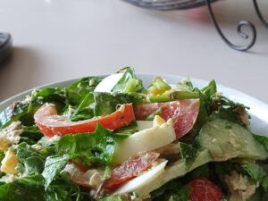 Signature Chef Salad Romaine, pickled cabbage, celery, carrot, onions, cucumbers, tomatoes, olive oil,  and vinegar.